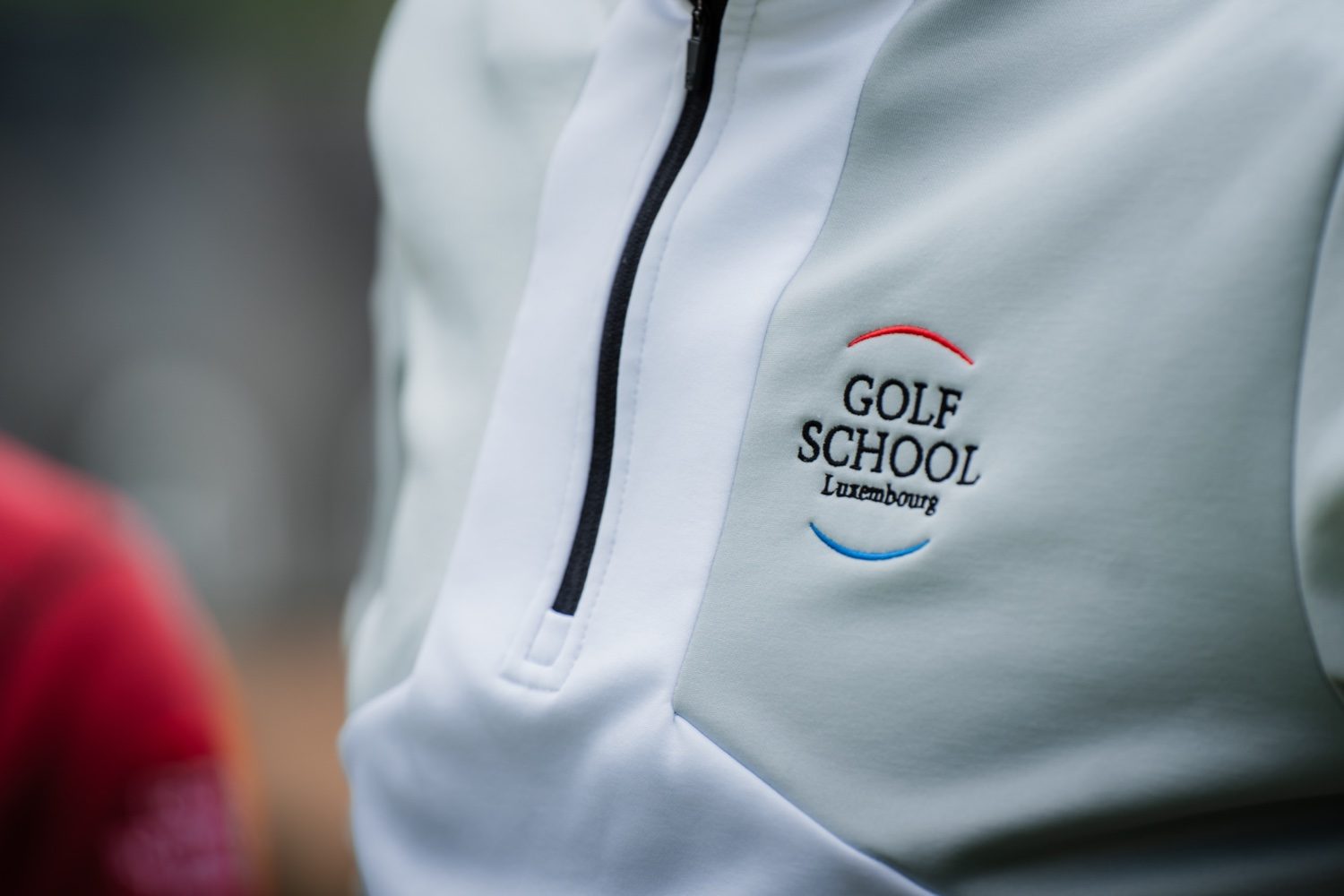 GolfSchool Luxembourg logo embroidered on a coach's jacket